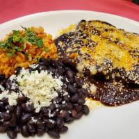 Enchiladas de Mole · corn tortilla, chicken tinga, mole colorado, manchego & jack cheeses, sesame seeds

served...