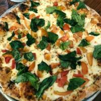 White Pizza · Ricotta cheese, fresh tomatoes, mozzarella cheese and fresh basil.