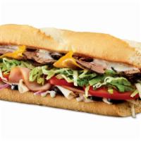 Traditional Sub · Black Angus steak, turkey, ham, cheddar, black olives, lettuce, tomatoes, onions, and ranch.