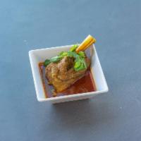 Kuna · LAMB shank cooked on a very low heat in a special curry sauce. Garnished with ginger, green ...