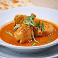 Chicken Curry · Chicken cooked in onion based gravy with Indian exotic spices.