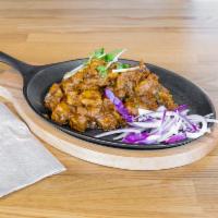 Tava Mughlai Korma (Chicken/Lamb/Goat) · Noble Moghul dish with Rich ingredients prepared with roasted spices.