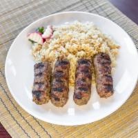 Kafta Kebab · Seasoned ground lamb, with onion, parsley, and mint, grilled over an open flame and served w...