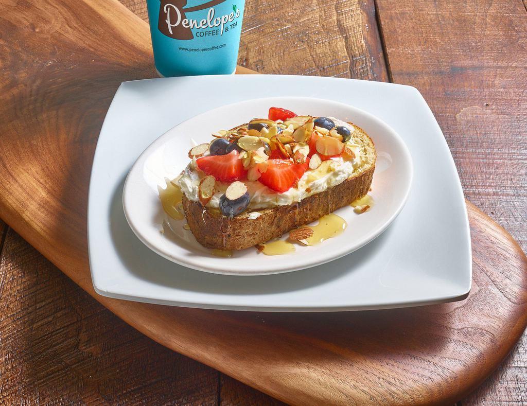 Honey Berry Toast · Toast, cream cheese, sliced strawberries, blueberries and almonds drizzled with honey.
