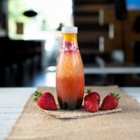 Bottled Crimson Peach Fruit Tea · Fresh strawberries and peach bits in peach strawberry green tea.