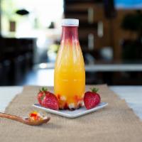 Fall Into Passion Fruit Tea · Fresh strawberries and passion fruit pulp inside passion fruit juice.