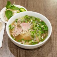 11. Special Pho-Pho Dac Biet · Raw eye round steak, well-done brisket, tendon, tripe, beef meatball. Our special broth made...
