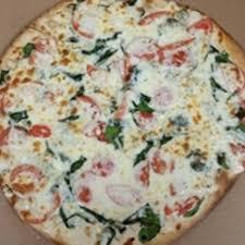 Chicken Alfredo Pizza · Homemade alfredo sauce, grilled chicken and sautéed spinach with sliced tomato on top.
