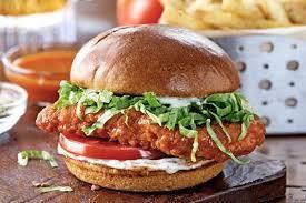 Buffalo Chicken Sandwich + French Fries · A crispy chicken breast tossed in buffalo sauce served with lettuce, tomato, onion & a side ...