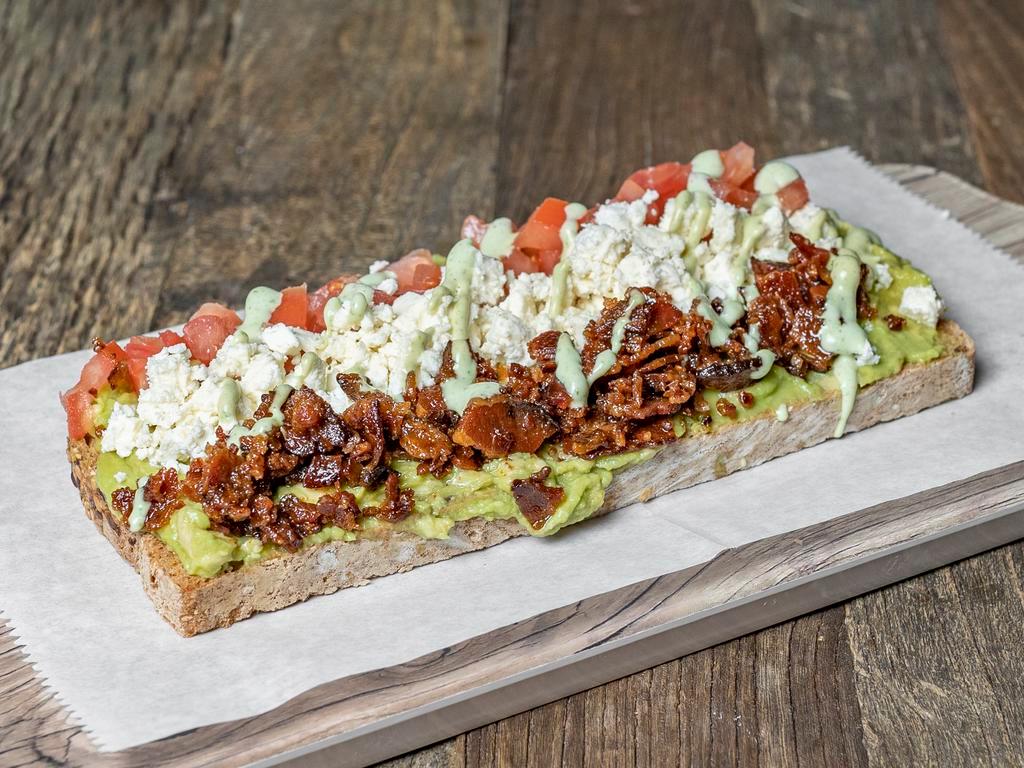 Avocado Toast · Multigrain toast, fresh avocado, tomato, bacon, feta cheese, and sesame seeds. Add sauce for an additional charge.