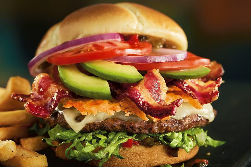 The Madlove Burger · A Cheddar-and-Parmesan crisp, Provolone, Swiss, jalapeño relish, candied bacon, avocado, citrus-marinated tomatoes and red onions with shredded romaine on a toasted brioche bun.