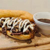 Woodstock’s Famous Prime Rib Dip · Smoked prime rib served on a grilled hoagie with sauteed onions and mushrooms, topped with p...