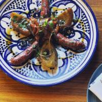 Lamb merguez · grilled lamb sausages with artichoke hearths, tomatoes, onions.