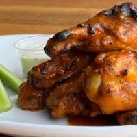 Wood-Grilled Jumbo Wings · Pick your sauce: housemade BBQ, Buffalo, Garlic Parmesan, Lemon Pepper or Honey Sriracha 