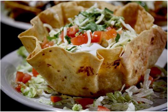 Taco Salad · A large fried flour tortilla shell stuffed with seasoned ground beef or spicy chicken topped with cheese dip, lettuce, tomato, shredded cheese, sour cream.