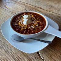 Chili · 3 bean & beef chili made inhouse w/a blend of spices.  Topped w/shredded cheese and sour cre...