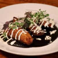 Platanos Fritos con Mole Negro  · 3 fried plantains served over mole negro, topped with cheese and sour cream.