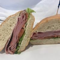 New York Hot Pastrami · Served with mayo, mustard, melted Swiss cheese, lettuce, tomato, grilled onions.