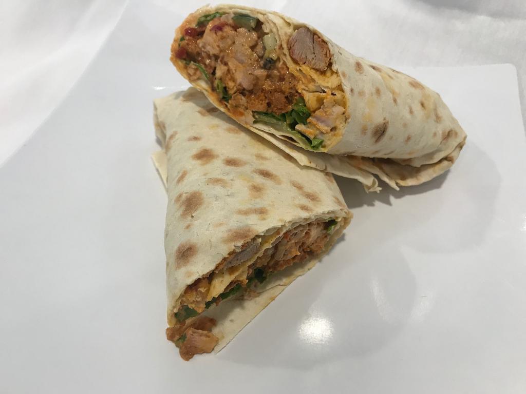 Shawarma Wrap · Beef or chicken marinated in Mediterranean spices, hummus, lettuce, tomatoes, onions, pickles and tahini salad.