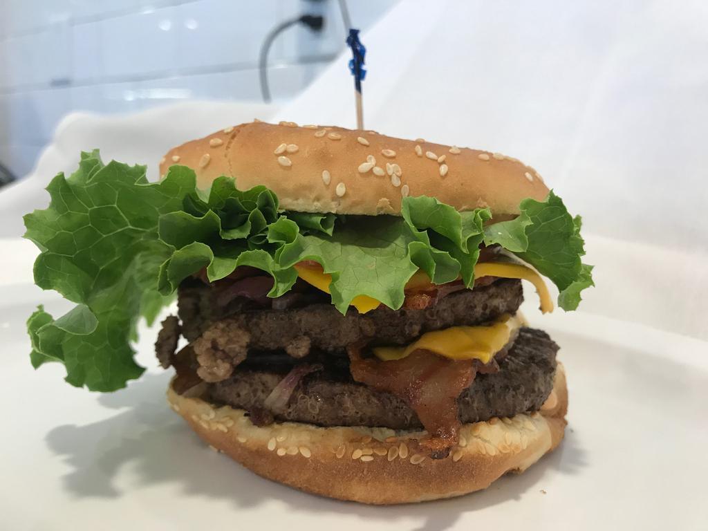 Double Cheese Burger  · All-natural, charbroiled, 100% Black Angus beef, 80/20 1/3 pound patty comes with, our signature sauce, American cheese, lettuce, tomato & grilled onions.