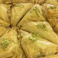 Warbaat · Layers of filo pastry filled with creme and topped with simple syrup and crushed pistachios.