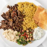 Lamb and Beef Shawarma Plate · Thinly sliced marinated lamb and beef served with salad, hummus and rice.
