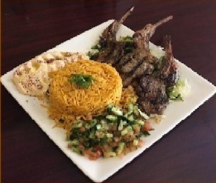 lamb chop plate · 4 lollipop lamb chops on a bed of rice with a side salad.