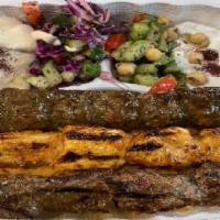 Kebab Trio Plate  · All three kinds of kebab: lamb, chicken and kefta  on a bed of rice  hummus, salad and pita ...