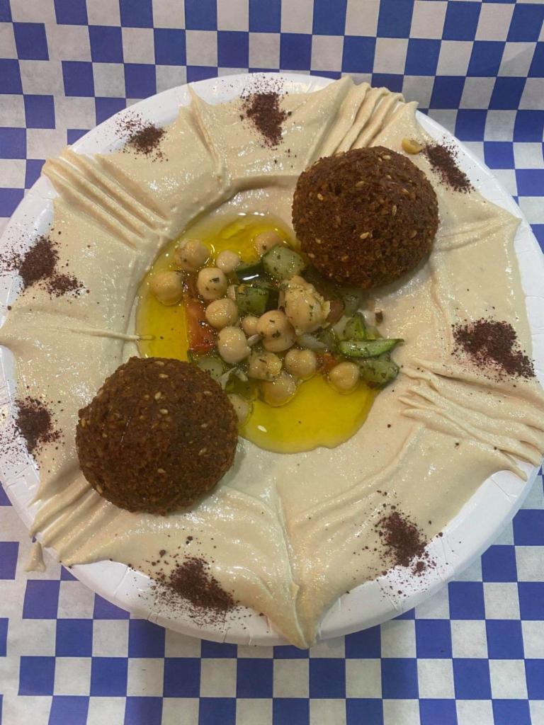 Hummus Plate · Garbanzo beans with garlic lemon juice, tahini, olive oil and spices with 2 falafel and pita.