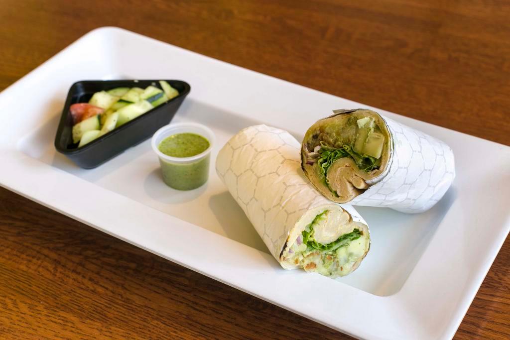 Veggie Wrap · Seasoned potato patty, tomatoes, cucumbers, cilantro, onion, shredded lettuce and chutney. Served with a choice of salad.