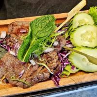 Ribeye Skewer · Ribeye steak marinated with Thai herbs served with spicy tamarind sauce. 
