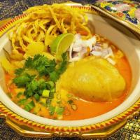 Khao Soi Chicken · Yellow curry noodle soup served with chicken drumstick.