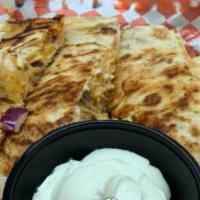 Chicken Quesadilla · Fresh-grilled chicken, onion, shredded cheese blend, and Z sauce with sides of sour cream.
