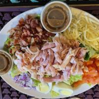 Chef Salad · Piled high with ham, turkey, bacon, egg, onion, tomatoes and sliced Swiss cheese. Served wit...