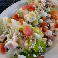 CLIFFS WEDGE · Iceberg wedge topped with bacon, egg, avocado, red onion, scallions, feta, egg, and Cliffs S...
