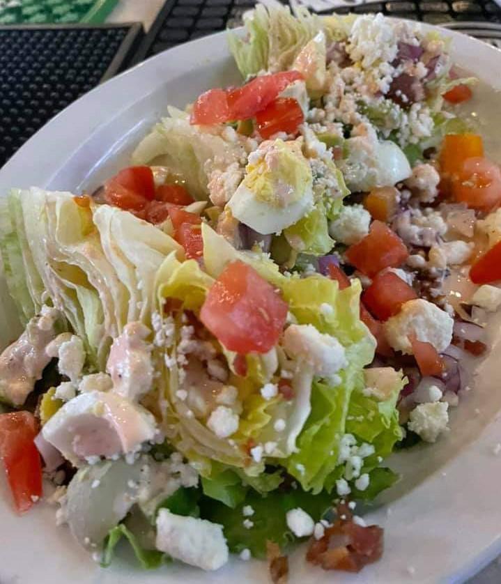 CLIFFS WEDGE · Iceberg wedge topped with bacon, egg, avocado, red onion, scallions, feta, egg, and Cliffs Signature dressing