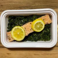 Lemon Squeezed Salmon · Lemon squeezed salmon over a bed of spinach with a side of yellow squash.