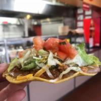 Tostada · Crispy corn tortilla topped with choice of filling, refried beans, salsa, lettuce, cheese, g...