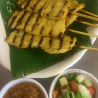 1. Chicken Satay · Chicken on a skewer served with peanut sauce and cucumber salad.