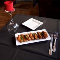 Sweet and Sour Chicken Wings · Fried chicken wings glazed with a spicy crushed red pepper and honey sauce.