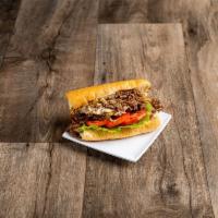 Philly Style Cheese Steak Sub · Real rib eye beef steak or chicken breast steak on a sub roll with cheddar cheese sauce, let...