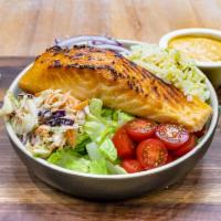 Salmon Bowl · A 7 oz. grilled salmon filet, lettuce, tomato, corn salsa, coleslaw, rice, and dressing.