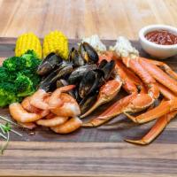 # 63 Snow Crab Leg Platter (Large) · Two snow clusters, 14 large steamed shrimp, 14 mussels, 14 crawfish in garlic-butter sauce, ...