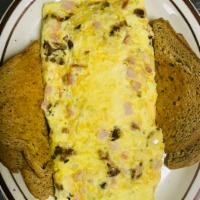 Farmers Omelette · Made with hash browns, bacon, ham, onion, and cheese.