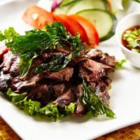 Crying Tiger · Tender flat iron beef steak grilled to perfection served with fresh vegetables, sticky rice ...