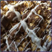 Zebra Caramel Popcorn · This confection will leave you speechless. Milk & white chocolate drizzled over caramel popc...