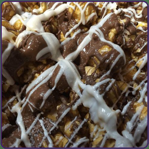 Zebra Caramel Popcorn · This confection will leave you speechless. Milk & white chocolate drizzled over caramel popcorn and sprinkled with sea salt, The buttery caramel, chocolate and sea salt is a perfect mix of taste.