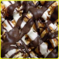 Tuxedo Popcorn · Premium caramel popcorn tossed in Decadent smooth dark chocolate and jazzy cool white chocol...