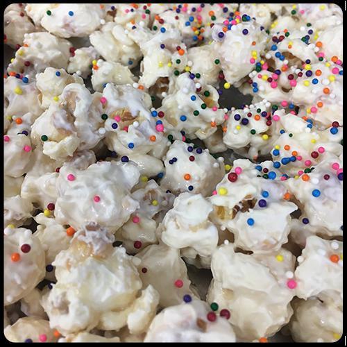 Birthday Cake Popcorn · Vanilla popcorn coated in creamy white chocolate, birthday cake special flavor, and sprinkled with rainbow sprinkles.