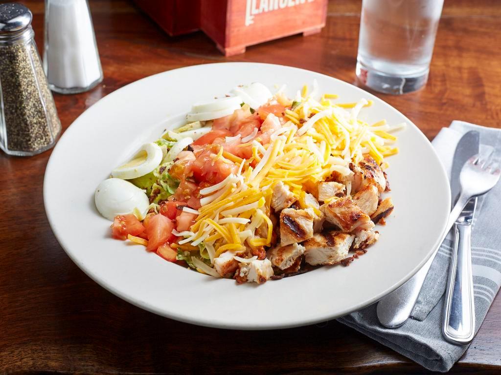 Cobb Salad · Grilled or fried chicken, mixed greens, cheddar jack, tomatoes, blue cheese crumbles, egg and bacon. Tossed in honey mustard vinaigrette 